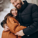 Couple together at winter time outside the street